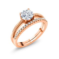 a rose gold engagement ring with diamonds on the band and a round diamond in the center