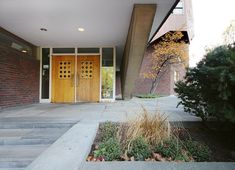 an entrance to a building with two wooden doors