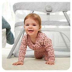 a baby crawling on the ground next to a chair