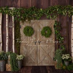 a wooden door surrounded by potted plants and greenery on the side of a wall