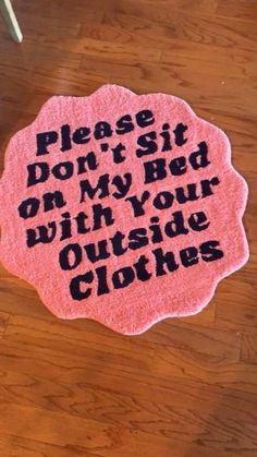 a pink rug that says please don't sit on my bed with your outside clothes