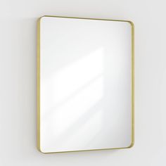 a mirror mounted to the side of a wall next to a white wall with a yellow frame