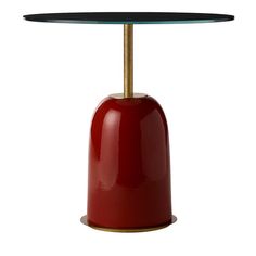 a red table with a black top and gold base on white backgrounnd