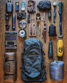 the contents of a backpack laid out on a wooden floor