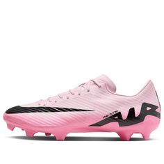 a pink soccer shoe with black accents on the soles and bottom part of it