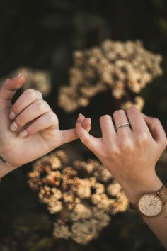 two hands reaching out towards each other with one hand holding the other's finger