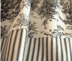 the curtains are lined up with black and white striped fabric, which has trees on them