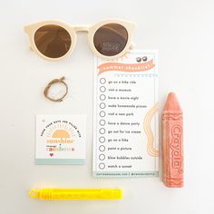 the contents of a summer checklist laid out on a white surface next to a yellow marker