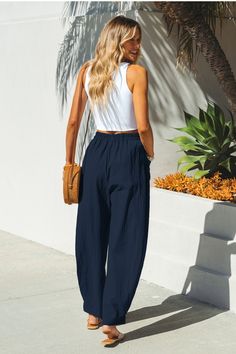 The Navy High Waist Tapered Pant is ready for warmer weather. Crafted from soft woven fabrication, this pair of tapered pants features an elasticized high-rise waist for everyday comfort. Product code: CAA02D4C002UU Features:  Woven Elasticized high-rise waist Side patch pockets Tapered leg Material: 100%COTTON Lining: 92% Polyester, 8% Spandex. Blue Pants Summer Outfit, Navy Blue Linen Pants Outfit, Navy Linen Pants Outfit, Blue Linen Pants Outfit, Navy Pants Outfit, Navy Blue Linen Pants, Pant Outfits For Women, Navy Linen Pants, Chic Minimalist Style