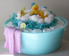 a blue bowl filled with bath toys on top of a table