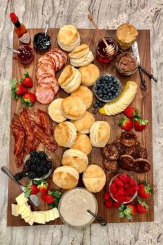 a wooden cutting board topped with lots of food