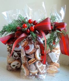 a bag filled with cookies and candies on top of a white counter next to a red bow