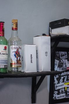 several liquor bottles are sitting on a shelf