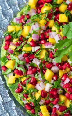 a salad with pomegranate, onions and cilantro