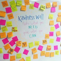 a bulletin board with post - it notes on it and the words, kindness wall