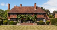 a large brick house with ivy covered windows