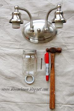 a hammer, mason jar and other items on a table