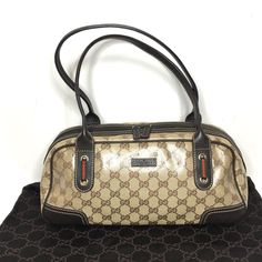 Authentic Gucci Princy Bag. Made In Italy. Monogram Glossy Very Durable Coated Canvas With Brown Leather Trims And Handles. Signage Red And Green Ribbon Accents. Very Good Condition. Canvas In Very Good Condition, One Small Pink Stain. Handles Are Strong, The Bag Fits Comfortably On A Shoulder. Pet & Smoke Free Environment, No Odor. Protective Metal Legs On The Bottom. Zipper Works Properly. Dark Lining Inside. One Side Zipper Pocket Inside. Dust Bag Included. Classic And Timeless Gucci Princy B Green Ribbon, Gucci Bag, Leather Trims, Inside Pocket, Side Zipper, Zipper Pocket, Bags Handbags, Brown Leather, Dust Bag