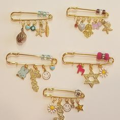 six different types of hair pins with charms on them, all in various colors and shapes