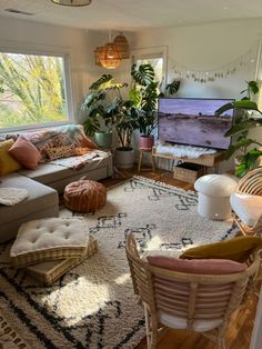 a living room filled with furniture and a flat screen tv