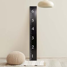 a large black and white ruler with numbers on it next to a small round ball