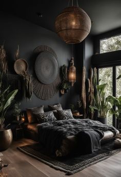 a bedroom with black walls and lots of plants on the wall next to the bed