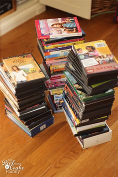 a stack of books sitting on top of a wooden floor next to a pile of other books