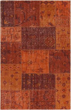 an orange and brown patchwork rug with many different designs on it's sides