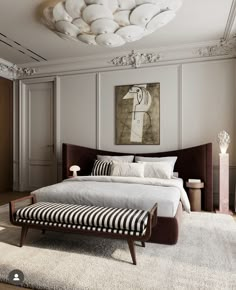 a bedroom with a large bed and white walls