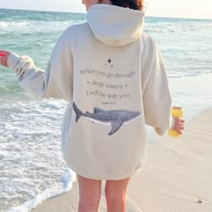 Dive into comfort and inspiration with our Whale Shark Hoodie featuring the powerful words of Isaiah 43:2: "When You Go Through Deep Waters, I Will Be With You." Crafted for ocean lovers, this hoodie embodies strength and support during life's challenges. Made with soft, cozy fabric and adorned with a majestic whale shark design, it's more than just a hoodie--it's a reminder of resilience and the boundless beauty of the ocean. Wear it proudly as you navigate life's currents and advocate for ocea Ocean Sweatshirt, Isaiah 43 2, Shark Sweatshirt, Shark Hoodie, Whale Shirt, Whale Shark, Deep Water, Oversized Style, Ocean Inspiration