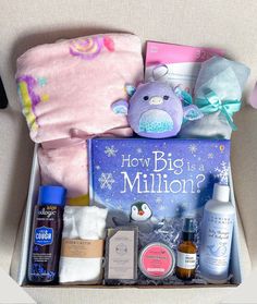 a box filled with personal care items on top of a couch next to a stuffed animal