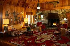 a living room filled with furniture and a fire place in the middle of a room