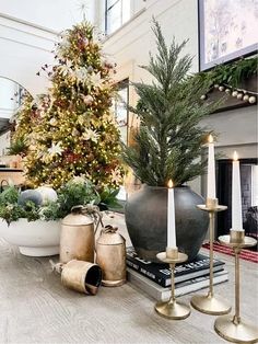 a christmas tree is in the middle of a room with candles and other holiday decorations