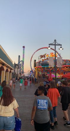 people are walking around at an amusement park