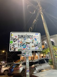 a street sign with many stickers on it