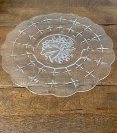 a clear glass plate sitting on top of a wooden table