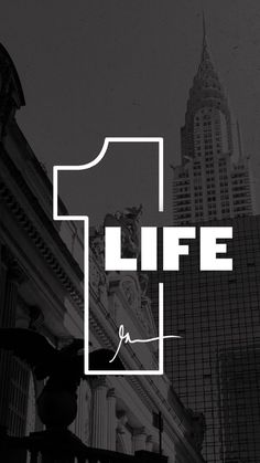 a black and white photo with the words life on it in front of tall buildings