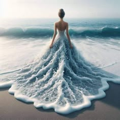 a woman standing in the ocean with her back to the camera, looking at the waves