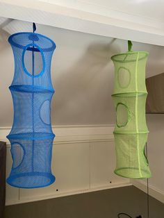 two blue and green hanging objects in a room