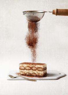 a piece of cake is being sprinkled with powder