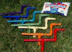 the cover of marshmallow shooters magazine, featuring four colorful pipes and a bag of candy