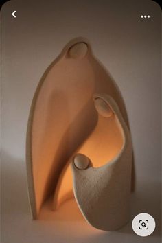 an abstract sculpture made out of clay with a light shining on the top and bottom