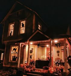 a house decorated for halloween with pumpkins and decorations