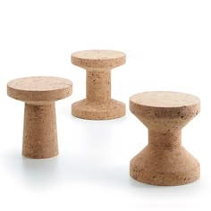 three small stools made out of cork are shown in this image, with one sitting on the floor