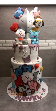 a three tiered cake decorated with cartoon characters