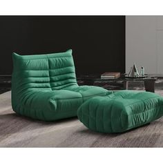 a large green chair and ottoman in a living room with a coffee table on the other side