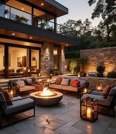 a fire pit sitting on top of a patio surrounded by furniture