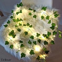 a white rug with ivy and lights on it