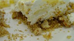 a piece of cake with white frosting and crumbs on the top is sitting on a plate