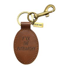 a keychain with the words f k the patriarchy on it